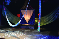 A stage decorated with large silk banners displaying various different patterns.