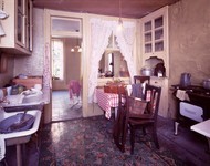 Color photograph of a staged tenement apartment.