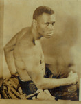 Portrait photograph of Paul Robeson in the title role of Eugene O’Neill’s The Emperor Jones in 1925. He is shirtless and stares directly at the camera.