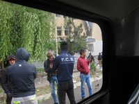 Picture includes four photographs from the conflict on May 21, 2014. These include a burned car with smashed windows, a two-story building (the courthouse), a building with a burned image of the president of Tajikistan, which is the prosecutor’s office, and a picture of a grassy hill in the distance with smoke billowing up to the right.