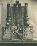 Publicity photo of Lawrence Tibbett in blackface performing the operatic adaptation of The Emperor Jones in 1933. He sits on a giant, oversized throne.