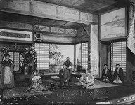 Photograph showing seven characters on a stage decorated to look like a Japanese house
