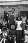 Activist Edward Rudolph and others standing and singing on the porch of the Autauga County Improvement Association office in Prattville, Alabama, on the day of a civil rights march, June 29, 1967.