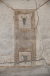 Fig. 21.615. Porticus 60, west wall, upper zone, above door to room 72, center, bucrania. Photo: P. Bardagjy.