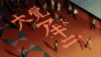 Akira's maniacs are painting "Wake up, Akira" in red ink with a giant brush on a red roof as police arrive to break up their illegal gathering.