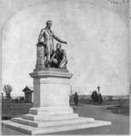 A photo that emphasizes the monument’s height. On the statue Abraham Lincoln stretches out his left arm above a kneeling male slave figure, who gazes up at Lincoln’s hand. Lincoln’s right hand is atop the Emancipation Proclamation.