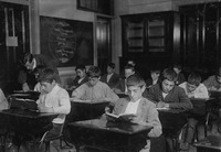 Fig. 6. A 1909 photograph of immigrants taking night school classes.