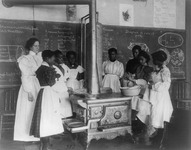 Fig. 7. A c. 1899 photo of African American girls being taught how to cook on a woodstove.