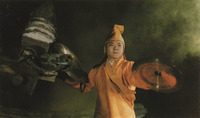 A shot from Legend of the Mountain showing a lama monk with cymbals at night.