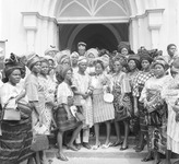 A group of women pose for photos at a wedding.