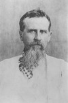 A black and white photograph of an Friedrich Ratzel looking directly at the camera. He has long goatee and moustache which are mostly white. His clothing is difficult to discern due to the photograph’s age.