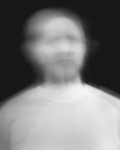 Pinhole camera image of a man’s face, features blurred, against black background.