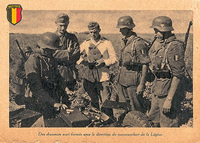 Spring-Summer 1942: a propaganda postcard showing antitank instruction in the presence of Walloon Legion Commander Lucien Lippert (taller of two with soft hats). Next to him is Pierre Dengis (white uniform). The latter was to become the commanding officer of the Assault Gun Company of the 5th SS Wallonien Assault Brigade. ( Coll. E. De Bruyne).