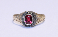 A gold filigree ring with inset gemstones.