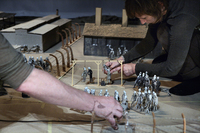 Figure 7.5. Two human actors move the small clay figures in Hotel Modern’s Kamp