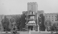 Fig. 6. The façade of the completed Center Building of St. Elizabeths Hospital, with horse and carriage in front, along with nearby trees and ivy-­covered walls.
