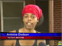 Antoine Dodson wearing a red bandana and looking flustered. A network news banner displays his name and identifies him as “victim’s brother.”