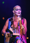 Performer Taylor Mac in drag, reading a book onstage in A 24-­Decade History of Popular Music in Brooklyn, New York.