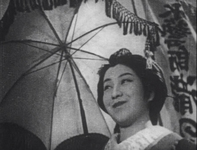 A woman carrying a frilled parasol. Calligraphy is visible in the background.