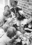 Bankole sits surrounded by seven other children.