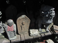 Closeup photograph of numerous prop statues and shrines.