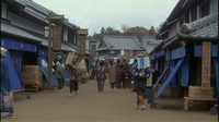 A market has various signs with blue and black calligraphy printed on them.