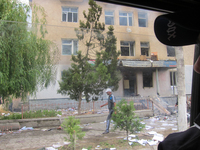 This is another government building that was burned down during the protests. Documents, some burned, some not, are spread out all over the ground. These documents belong to the government and are part of the historical records that were stored in the building, which had been there for eighty years. One man is walking by the building in the picture.