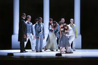The narrator, dressed in Lincoln’s black frock coat, stands far left. The dancers are clustered toward the back of the stage, watching the Lincolns in the foreground. Matteson curls into Bulbul, his arms wrapped around her waist. She wraps her arms around his head, pressing him to her chest. They look down together. Shayla-Vie Jenkins and LaMichael Leonard Jr. ghost Matteson and Bulbul’s embrace.
