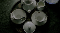 Tea tray from above, with china teapot, milk and sugar, and two teacups