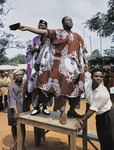Dr. Azikiwe and Dr. Michael Okpara standing on a wooden table, addressing a crowd.