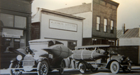 Wood-and-canvas canoes on a stop for provisions before a wilderness expedition prior to 1920.