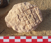 Fig 84: Inscribed Material from Bīr Shawīsh 25 shows jar lid with grating. The circumference is slightly irregular. It has a dimension of height 5.3 cm and maximum diameter of 5.4 cm.