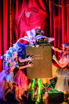 Performer Taylor Mac, dressed as a flower, being shut inside a giant Bible in a performance of The Lily’s Revenge.