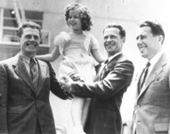 Soviet aviators as celebrities. Andrei Iumashev, Mikhail Gromov, and Sergei Danilin pose with American child star Shirley Temple in Los Angeles following their 1937 transpolar flight.