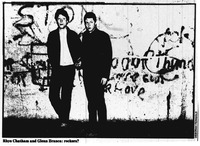 A low-­quality photograph reproduced from newsprint of Rhys Chatham and Glenn Branca standing against a graffiti-­covered wall. The newspaper caption reads, “Rhys Chatham and Glenn Branca: rockers?”