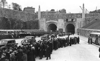 More than 50 men watch a parade of vehicles travel through the Lincoln Tunnel following the opening of the second tube in 1945.