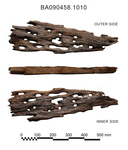 Ship timber. Very degraded surface. Elongated holes. 1 portion of edge preserved.  70 x 20 x 5cm.
