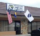 A photo shows the entrance of the Tampa Bay Bosnian Muslim-run masjid with three flags clearly showing whose masjid it is, and who is being served there. Such situation with flags is uncommon for US Muslim centers in general, but a common sight for most Bosnian Muslim places of worship throughout the U.S. In this instance they fly flags of the US, the flag of BiH, and the third white flag with golden lilacs is a flag that Bosnian Muslims see as their flag. The flag was created the Republic of BiH (RBiH) and was used by the Army of the Republic of BiH during the Bosnian War. This is somewhat different from the other situation noted earlier in the case of Utica, where the third flag is the official flag of the IZBiH, not the white and blue RBiH flag. In many cases, the white and blue RBiH flag will not be flown by West Bosnian congregations, yet the flag of the IZBiH would.