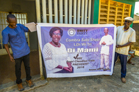 MT and Abubakar Juana hold a banner that announces him as running mate to Dr. Femi Claudius Cole of the Unity Party.