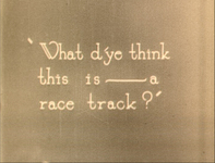 White intertitle text is superimposed over a surface background.