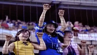 Figure 18. Three young women attending a Beatles concert in 1965 stand behind and cling onto a wire fence at Shea Stadium, eyes closed and mouths open as they scream in response to the presence of their idols.