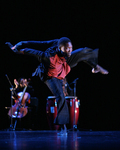 Fig. 17. Male dancer, black pants and jacket, red shirt. Bent over, left leg lifted high behind, knee bent; both arms behind him to his right. Focused gaze ahead.