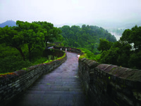 Photograph from the top of the Great Wall by the sea, facing along the pathway on top of the wall.