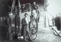 A hangar at the Kommendatskoe aerodrome in St. Petersburg during the Second Week of Aviation in 1911. Russian aviator Mikhail Efimov is seated on top of the airplane’s motor.