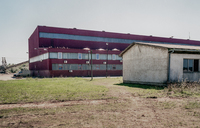 Color photograph of Omarska iron ore mine building which was used as a detention camp in 1992.