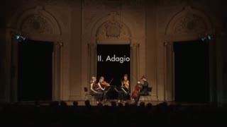 String quartet performs on a stage.