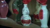 Handwritten labels on small porcelain vases. Contain medicine