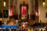 Image of a sanctuary inside a church with people in the foreground.