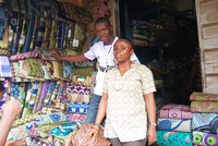Ogbonna Chidimma at Balogun Textile market, surrounded by different fabrics.