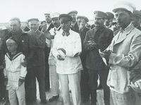 The ekipazh of the ANT-25 Stalin’s Route being met by Party officials and workers from TsAGI following their return from Udd. Valerii Chkalov appears on the far left of the photograph. Also visible are Nikita Khrushchev (to Chkalov’s immediate left), Klim Voroshilov (center with stars on lapel), and Josef Stalin.